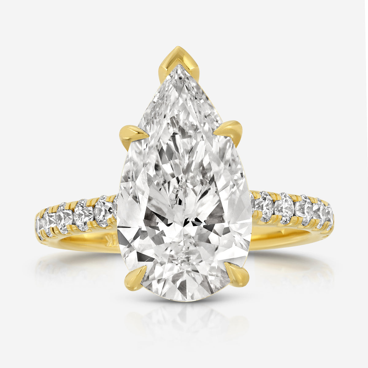 Front view of the TOVAA Moissanite Pavé Ring featuring a large pear-cut center stone and pavé diamond band in yellow gold.