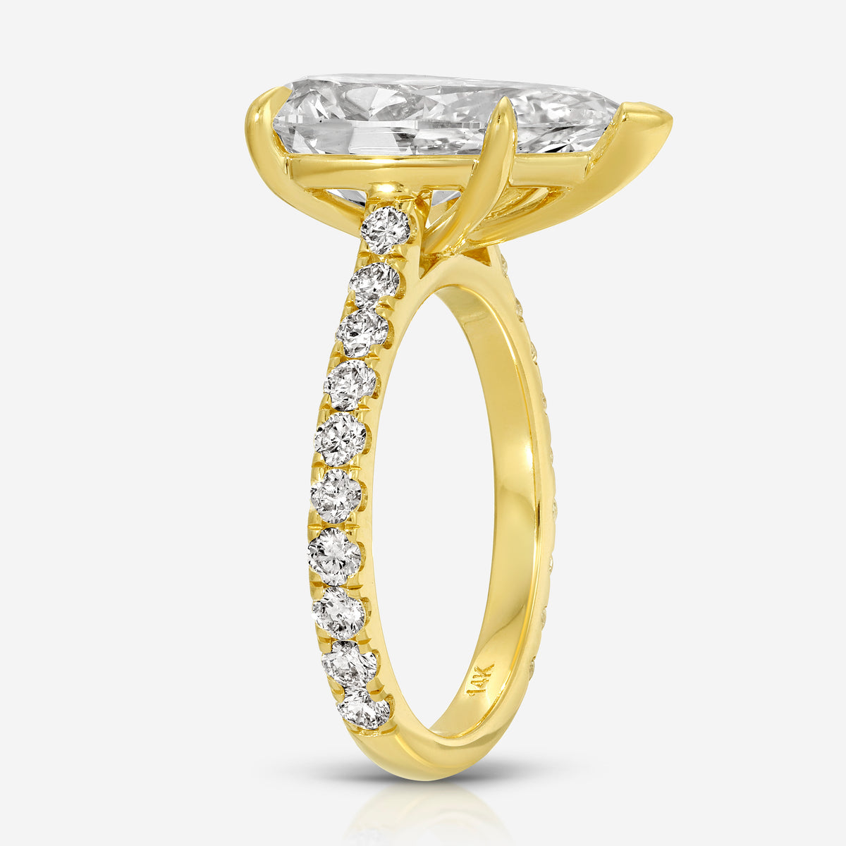 Side profile of the TOVAA Moissanite Pavé Ring highlighting the elevated pear-cut stone and pavé-set band in yellow gold.