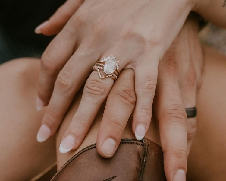 Contour wedding bands in yellow gold layered with an oval center ring, designed to follow the shape of the setting for a seamless fit.