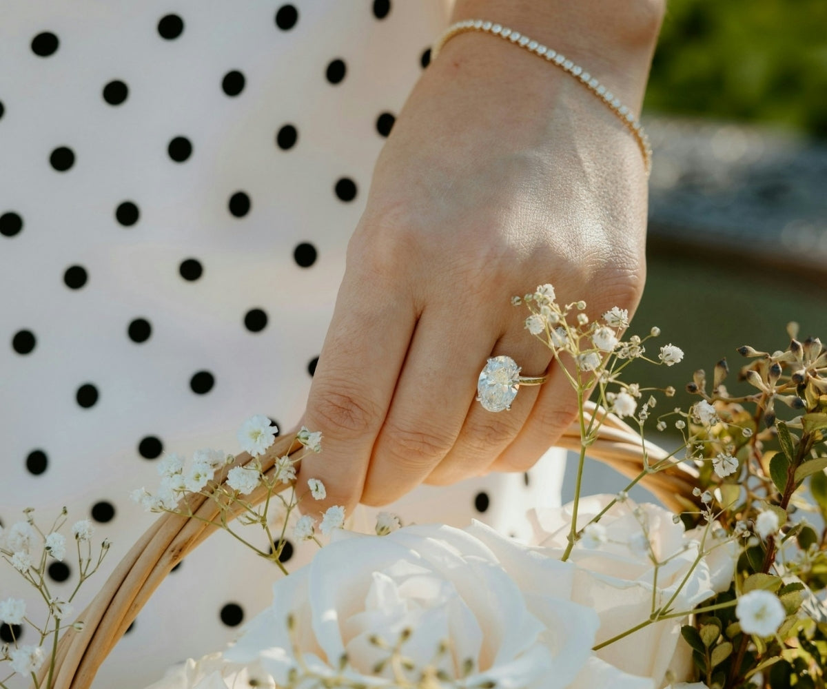 TOVAA oval moissanite engagement ring set in yellow gold with a solitaire oval center stone.